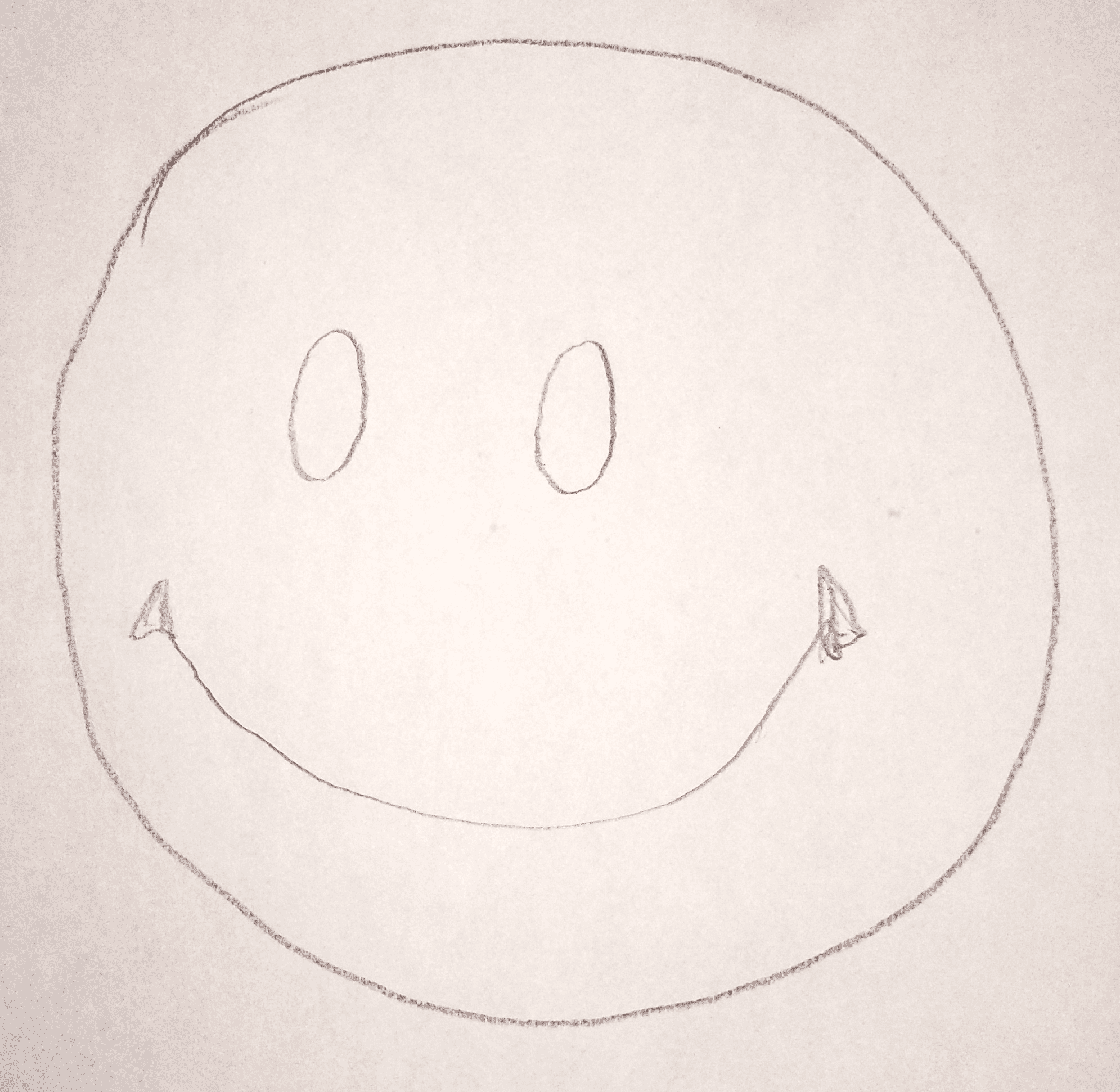 Circle with eyes and a curved smile line added in the bottom half